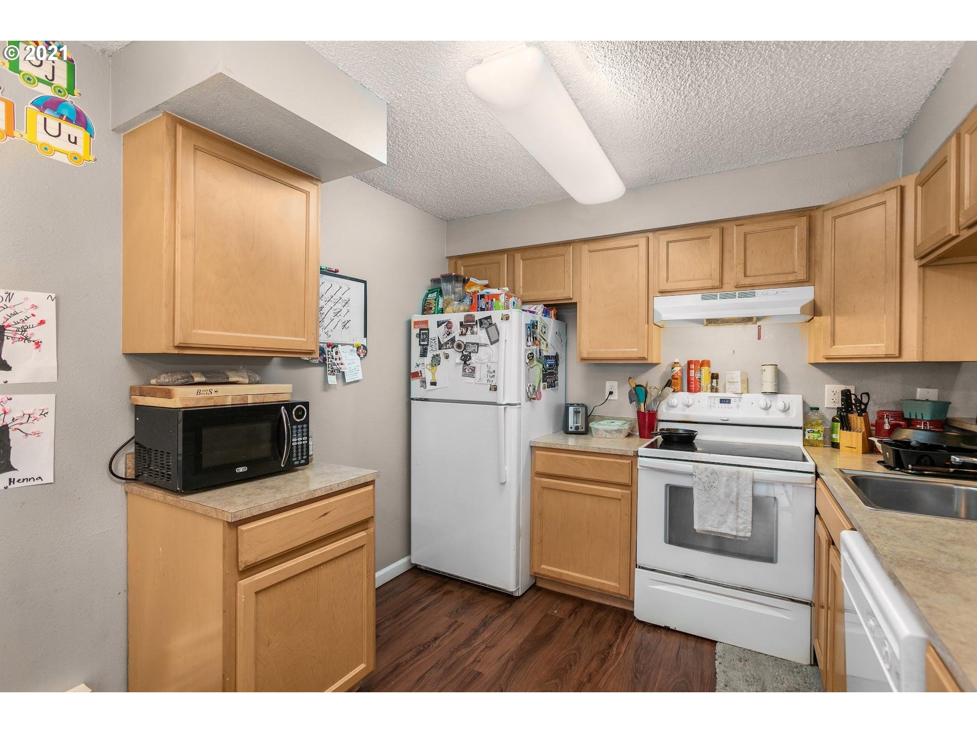 2943 Northeast Rene Avenue Gresham, OR 97030 - Photo 11 of 22 a kitchen with white cabinets and white appliances