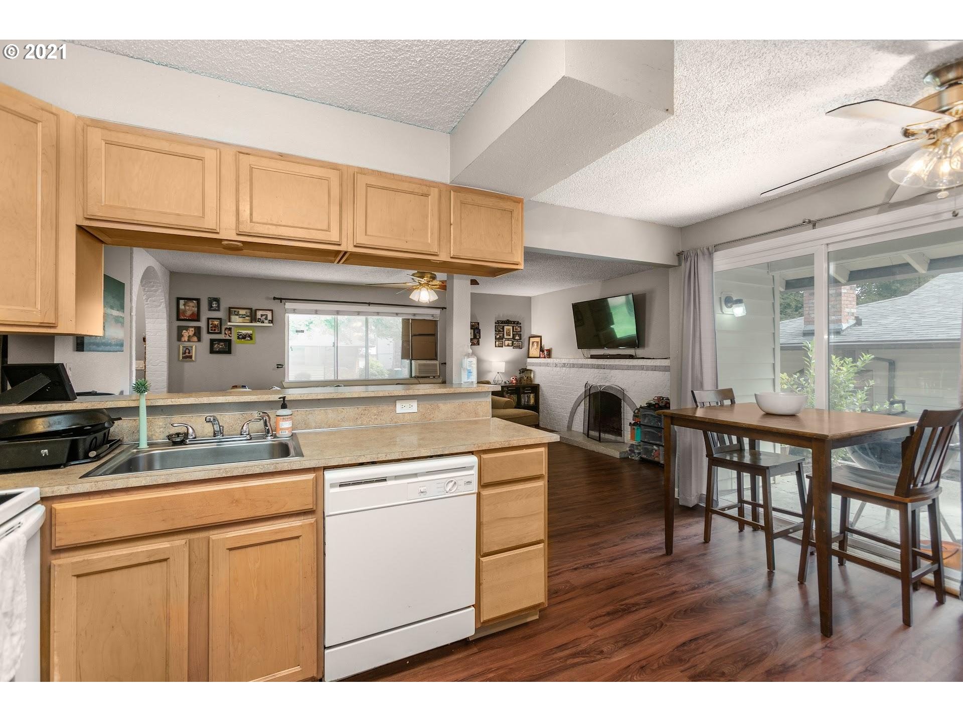 2943 Northeast Rene Avenue Gresham, OR 97030 - Photo 12 of 22 a kitchen with a table chairs and a refrigerator