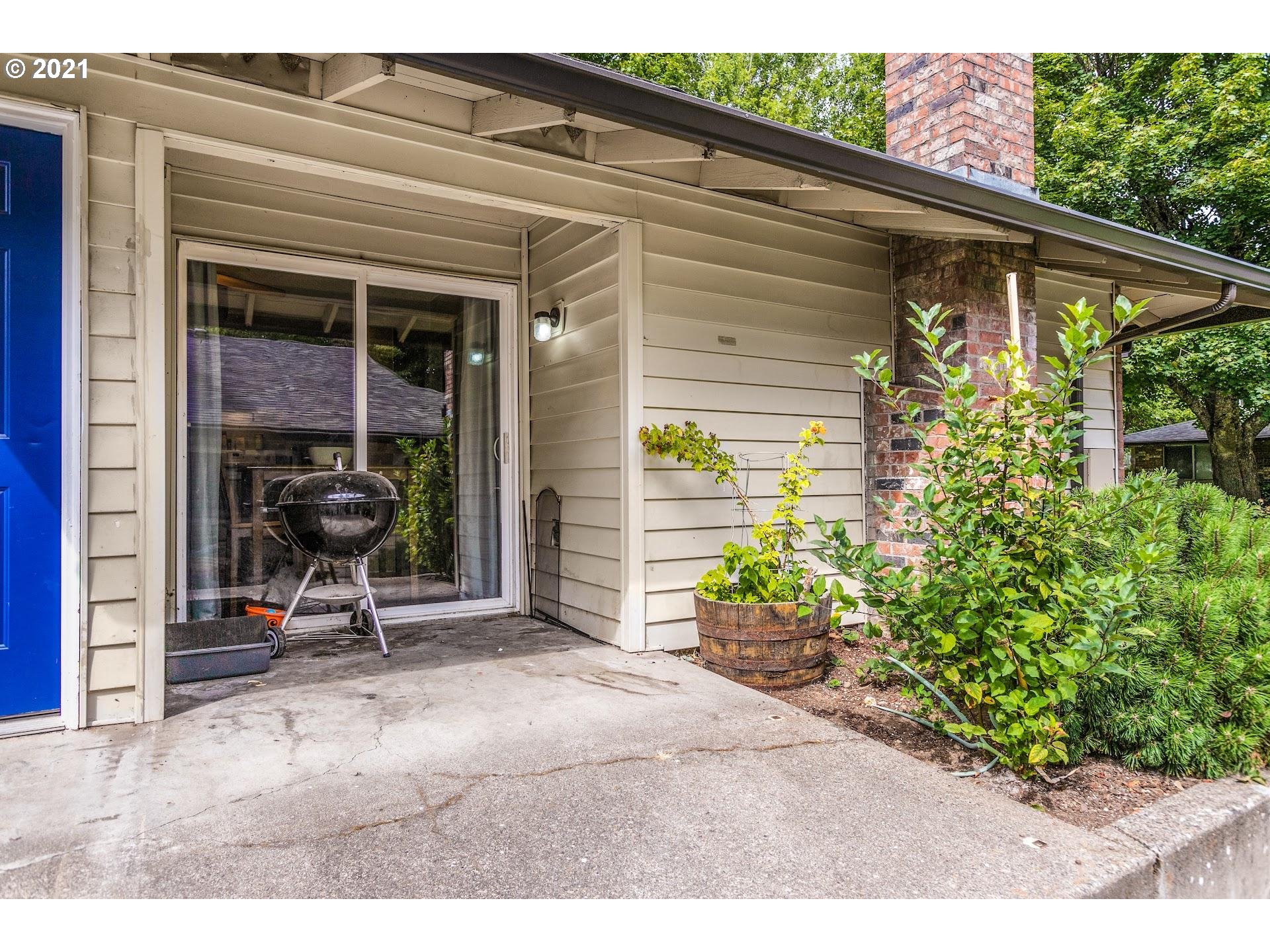 2943 Northeast Rene Avenue Gresham, OR 97030 - Photo 17 of 22 a view of a porch with chairs and potted plants