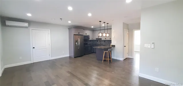 a view of kitchen with refrigerator stove and wooden cabinets