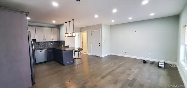 a kitchen with a refrigerator and a sink