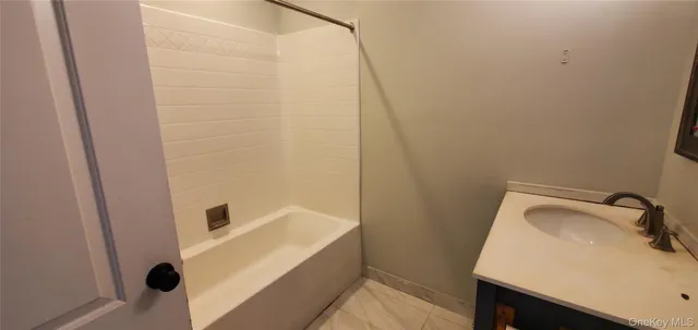 a bathroom with a sink and shower