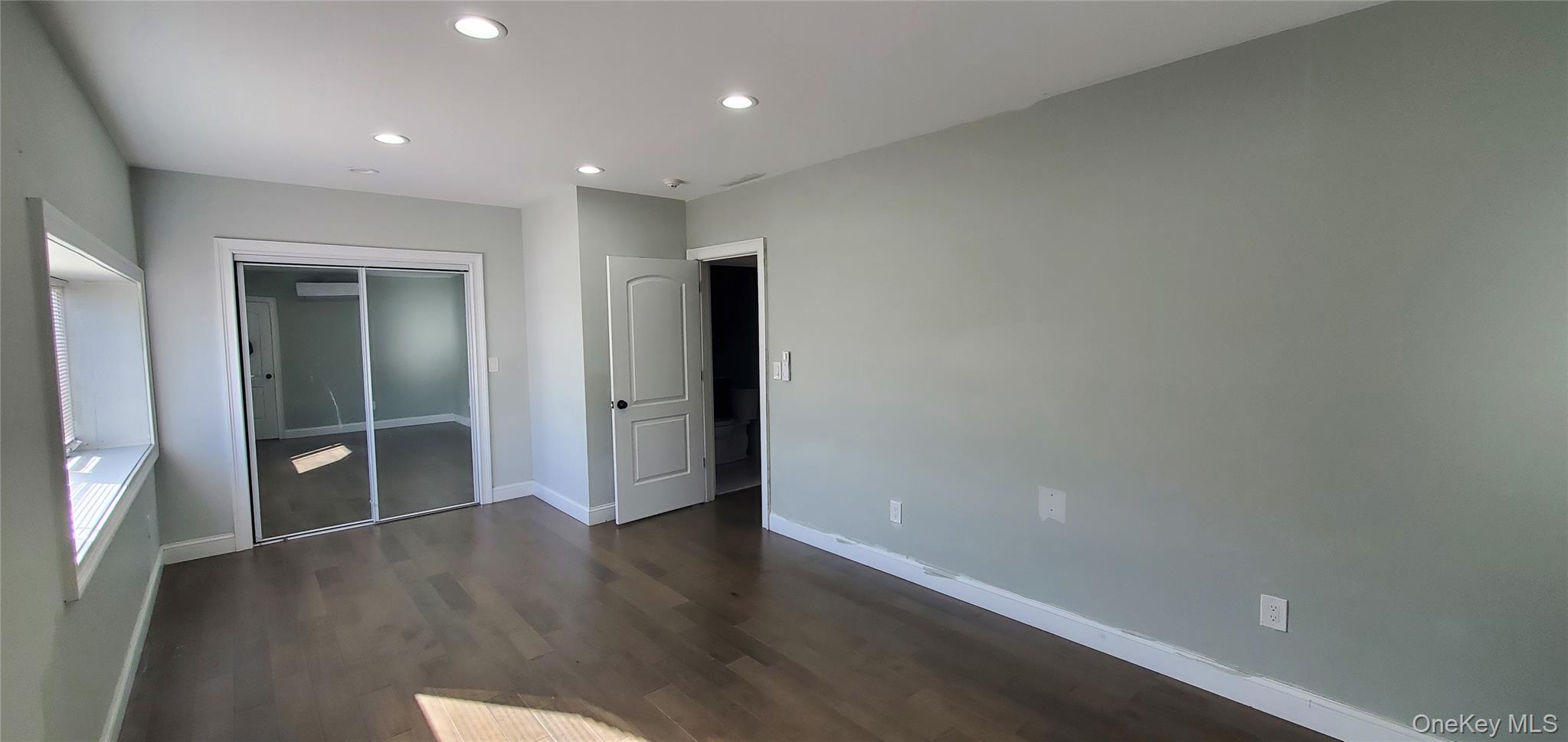 2755 West Main Street, Unit 1 Wappingers Falls, NY 12590 - Photo 9 of 15 an empty room with wooden floor & windows