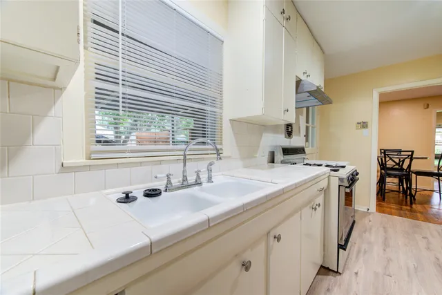 a kitchen with a sink cabinets and window
