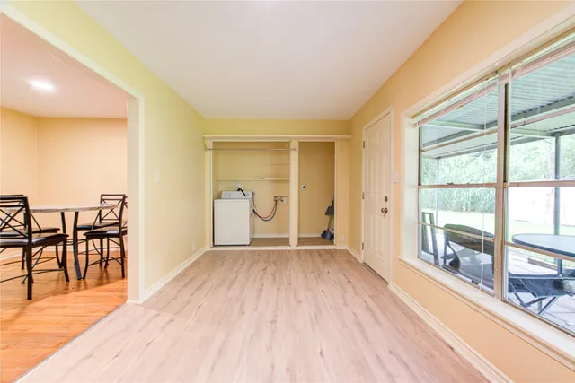wooden floor in an empty room with a window