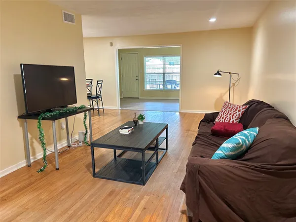 a kitchen with a stove and a wooden floor