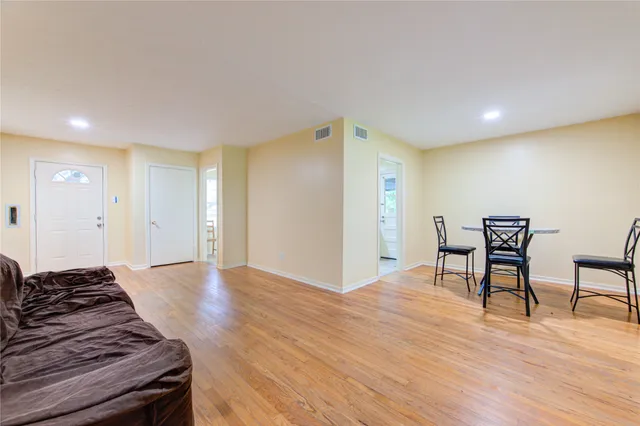 a view of a kitchen with wooden floor and a sink