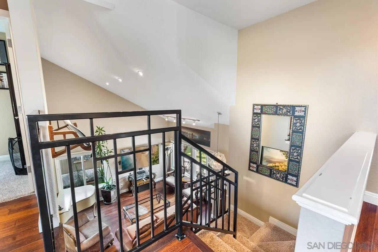 1815 Hawk View Drive Encinitas, CA 92024 - Photo 25 of 51 a view of staircase with lots of frames on wall and wooden floor
