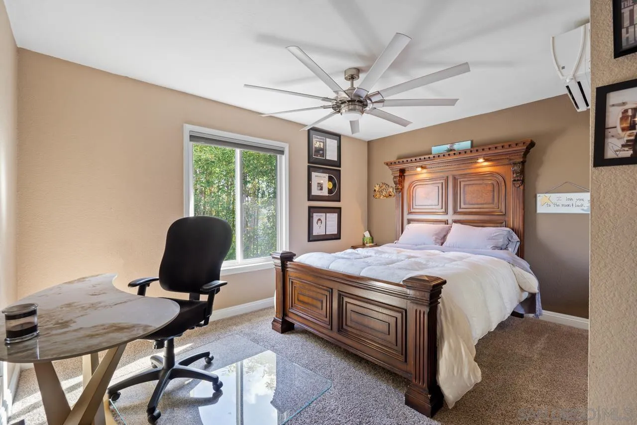 1815 Hawk View Drive Encinitas, CA 92024 - Photo 26 of 51 a bedroom with a bed table chair and a window