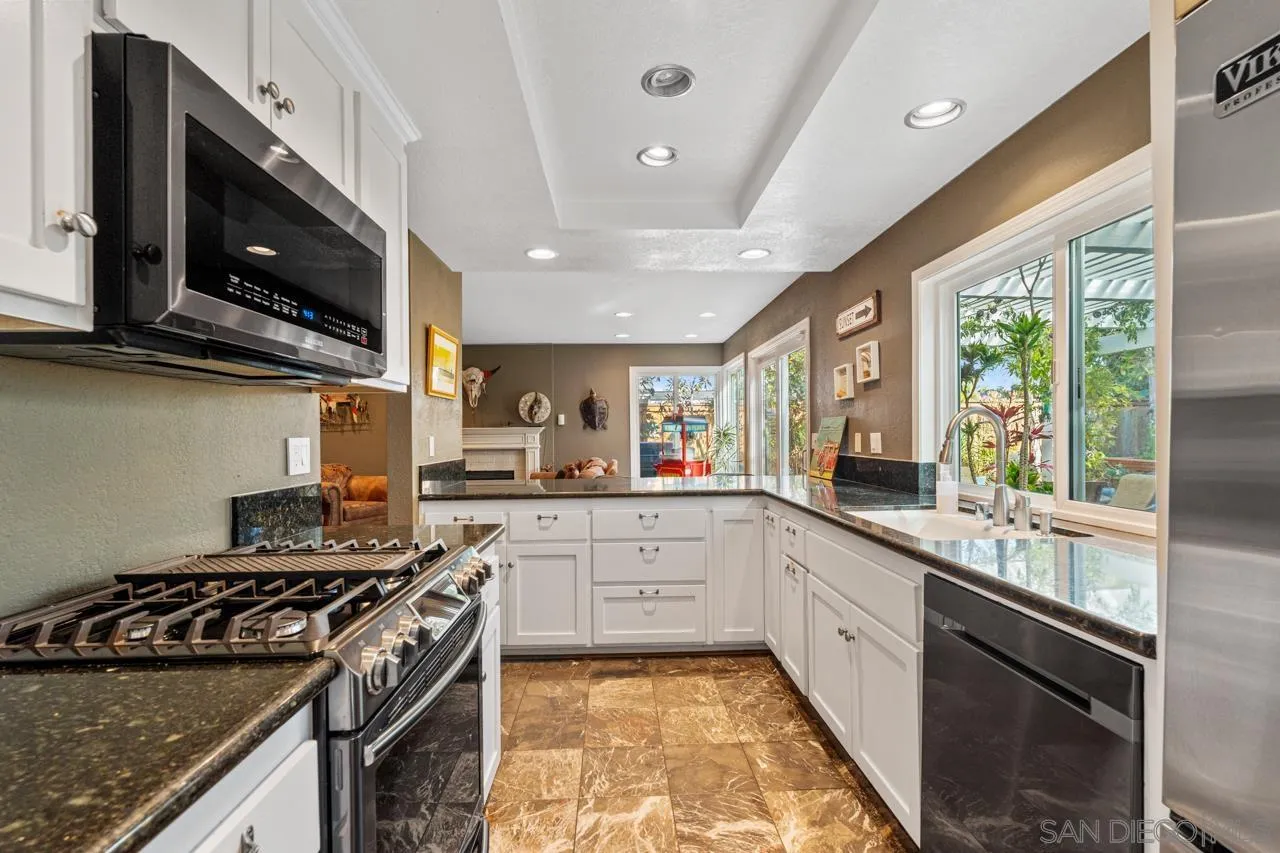 1815 Hawk View Drive Encinitas, CA 92024 - Photo 36 of 51 a large kitchen with stainless steel appliances granite countertop a stove and a sink