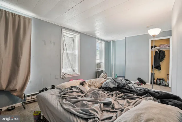 a bedroom with a bed and a mirror