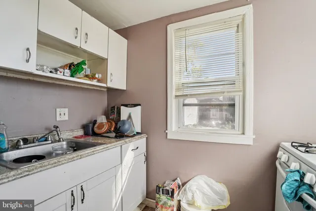 a kitchen with stainless steel appliances a sink a stove and a window