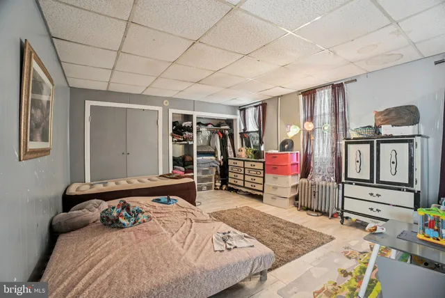 a bed sitting in a bedroom next to a window