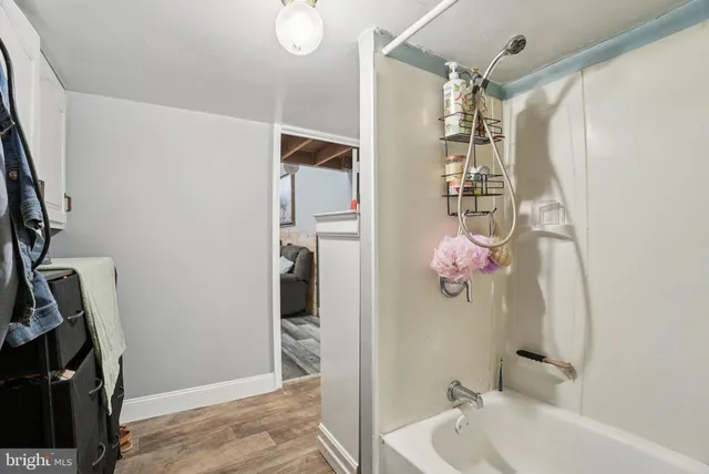 a bathroom with a sink mirror and shower