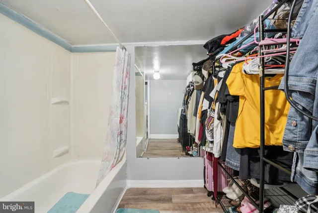 a view of walk in closet with clothes