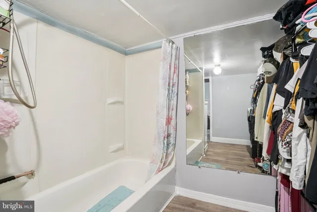 a bathroom with a bathtub and a shower