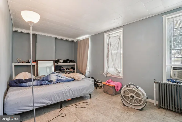 a bedroom with bed and window