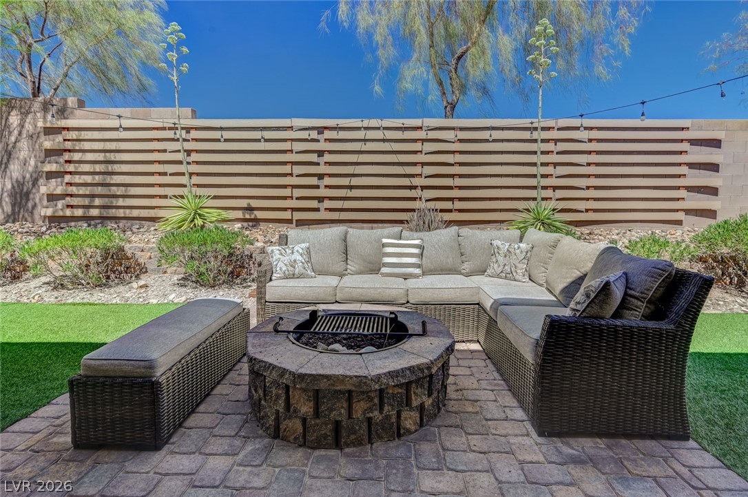 8197 Riley Love Street Las Vegas, NV 89139 - Photo 45 of 48 An inviting paver patio with a built-in fire pit offers an ideal spot for outdoor gatherings.