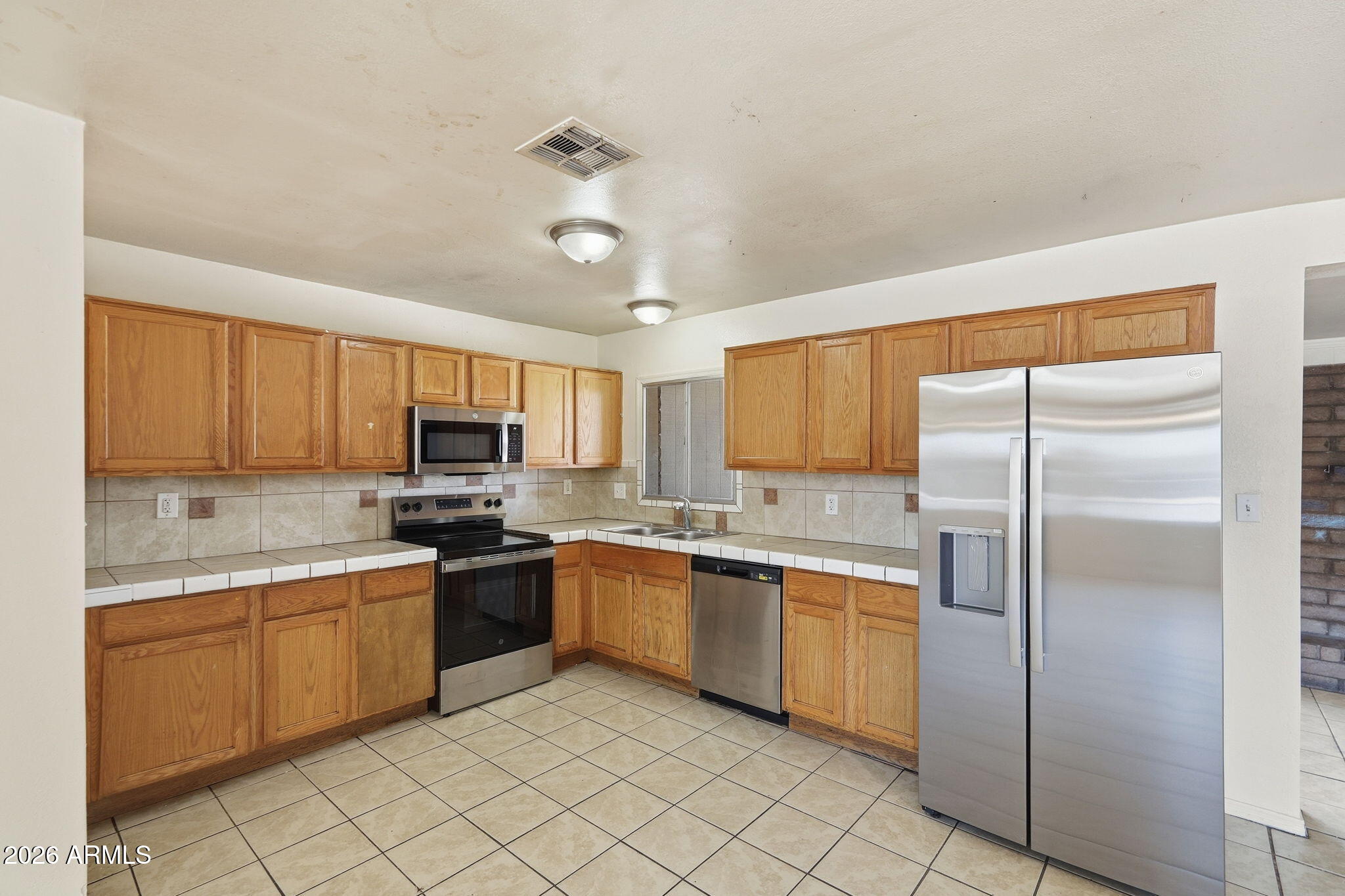 6452 West Thomas Road Phoenix, AZ 85033 - Photo 9 of 30 a kitchen with stainless steel appliances granite countertop a sink and cabinets