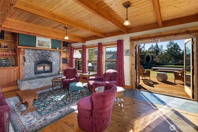 a living room with furniture a fireplace and next to a window