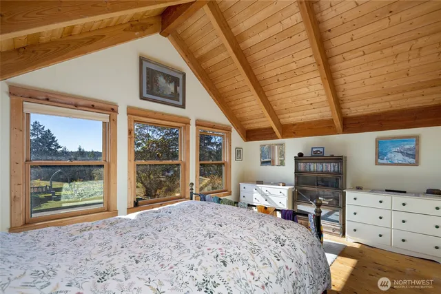 a bedroom with furniture and large window
