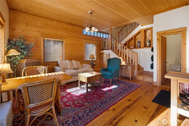 a living room with furniture a rug and a chandelier