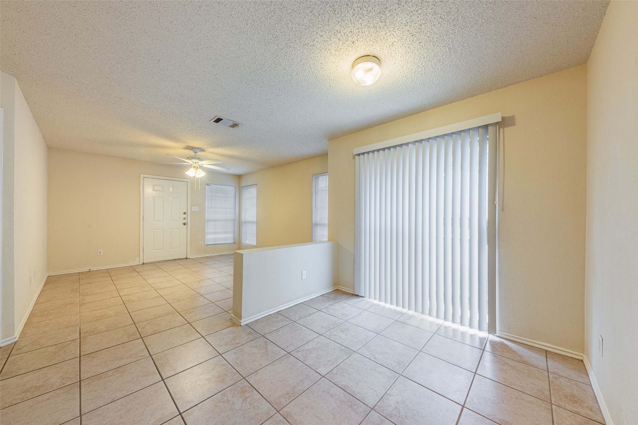 7216 Aldea Drive, Unit A Austin, TX 78745 - Photo 10 of 25 Bright interior space featuring light-toned tile flooring throughout