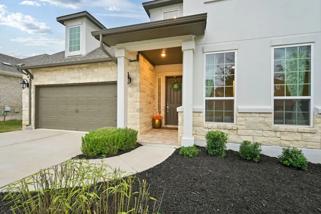 a front view of a house with garden