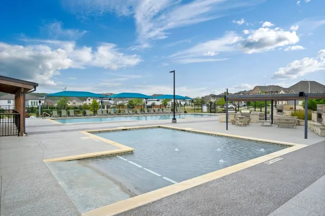 a view of swimming pool with outdoor seating