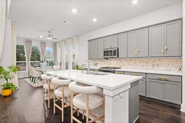 a kitchen with a sink cabinets and wooden floor