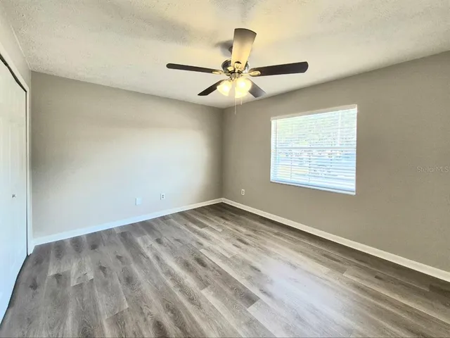 wooden floor in an empty room with a window