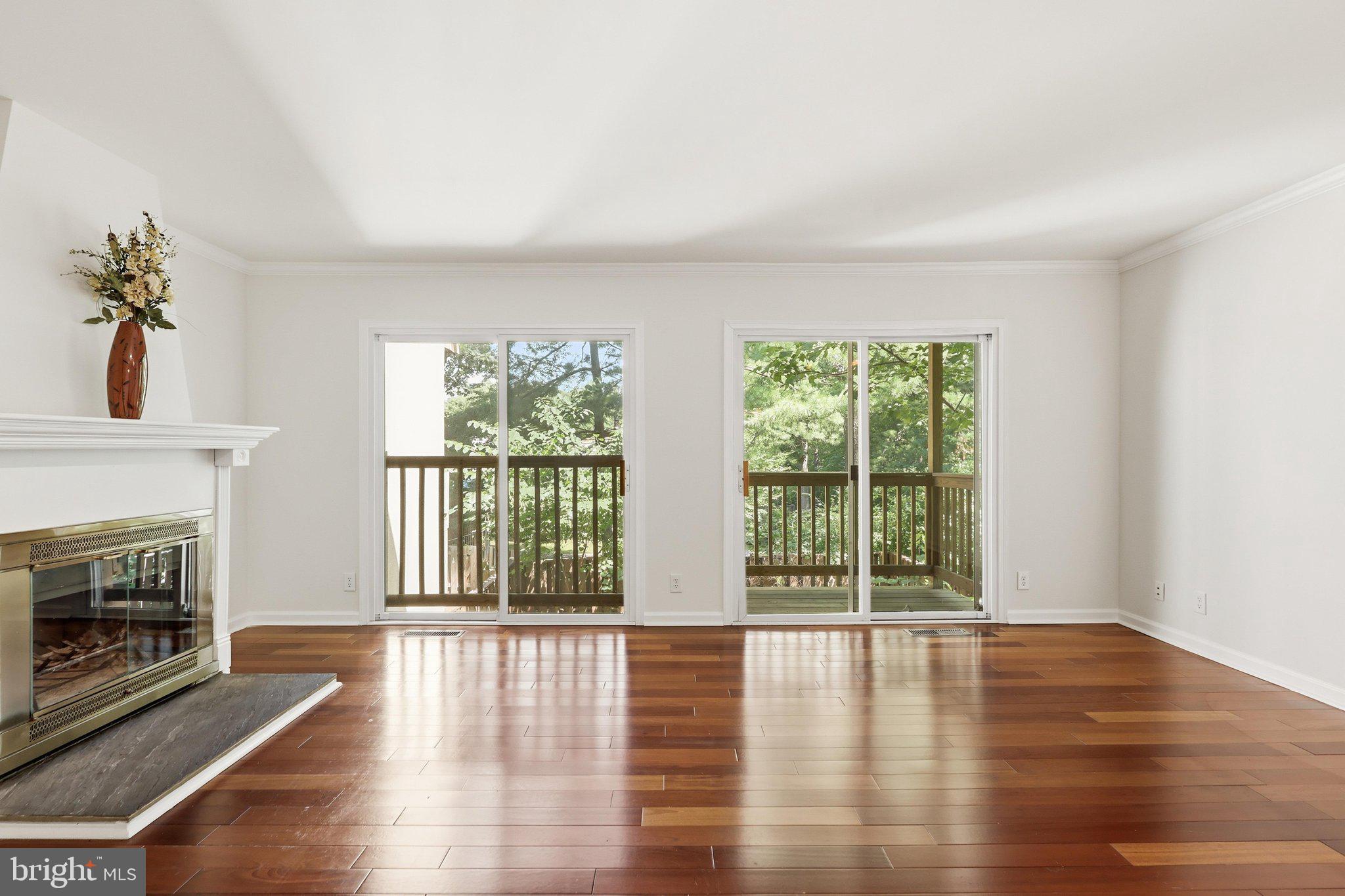 1651 Valencia Way Reston, VA 20190 - Photo 8 of 66 Living room with balcony overlooking backyard