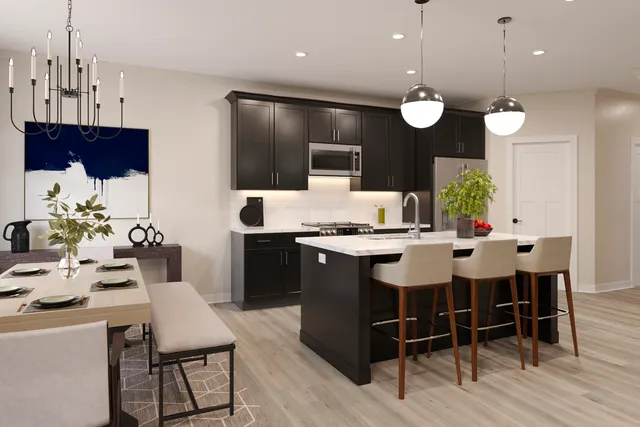 a kitchen with a dining table chairs and white cabinets