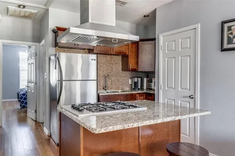 a kitchen with stainless steel appliances granite countertop a stove a refrigerator and a refrigerator