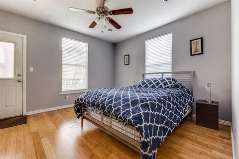 a bed sitting in a spacious bedroom next to a window