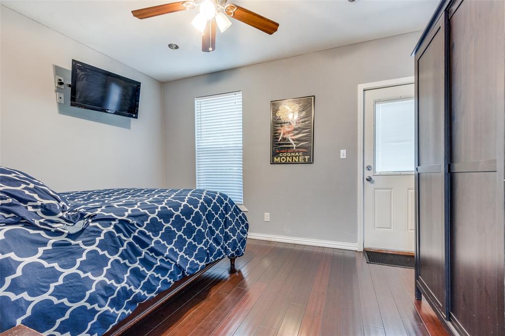 617 Haines Avenue Dallas, TX 75208 - Photo 17 of 29 a bedroom with a bed and a flat screen tv