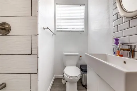 a bathroom with a sink a toilet and a shower