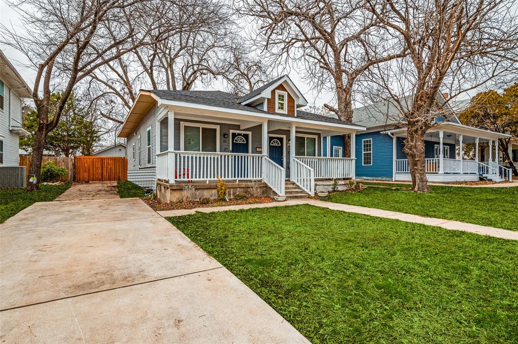 617 Haines Avenue Dallas, TX 75208 - Photo 3 of 29 a front view of a house with a garden and trees