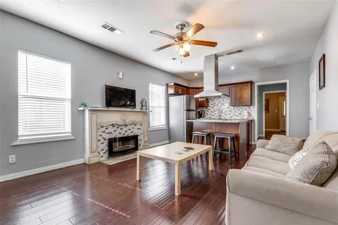 a living room with furniture a fireplace and a flat screen tv
