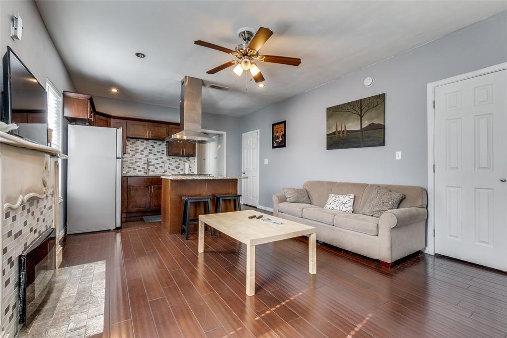 617 Haines Avenue Dallas, TX 75208 - Photo 10 of 29 a living room with furniture and a fireplace