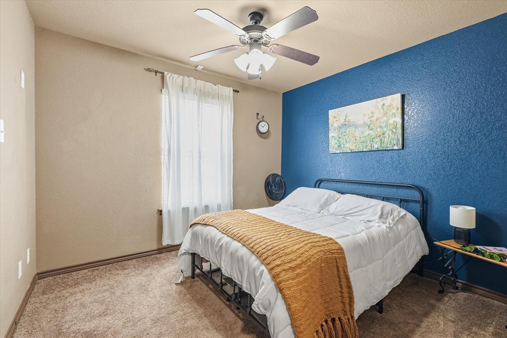 171 Ridge Top Drive Decatur, TX 76234 - Photo 25 of 40 a bedroom with a bed and a ceiling fan