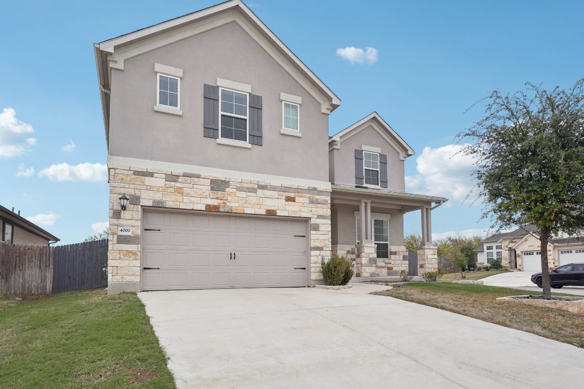 a front view of a house with a yard and garage
