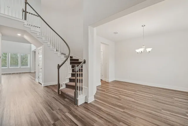a view of entryway and hall with wooden floor
