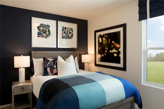 a bedroom with bed and wall painting