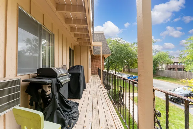 a view of balcony with two chairs and a table