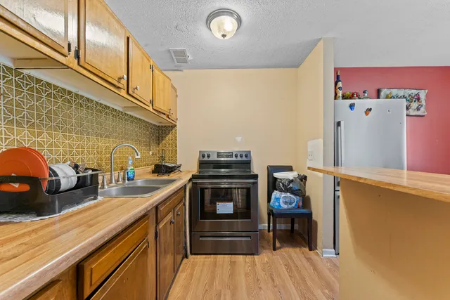 a kitchen with stainless steel appliances a stove and a refrigerator
