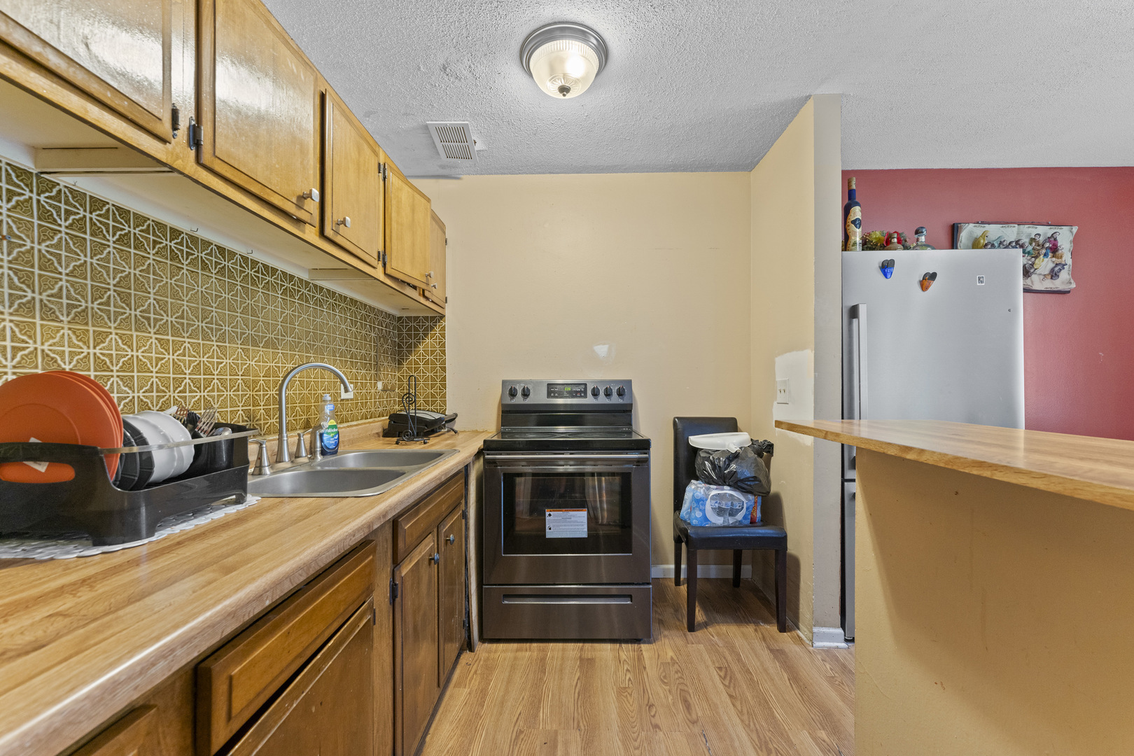 2504 West Algonquin Road, Unit 14 Rolling Meadows, IL 60008 - Photo 19 of 20 a kitchen with stainless steel appliances a stove and a refrigerator