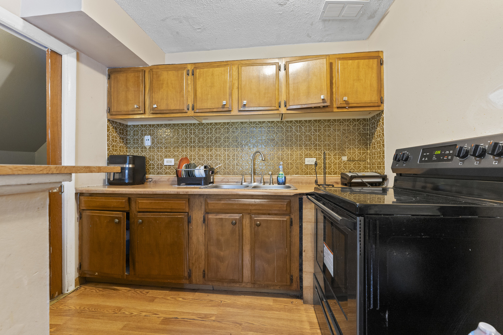 2504 West Algonquin Road, Unit 14 Rolling Meadows, IL 60008 - Photo 20 of 20 a kitchen with stainless steel appliances granite countertop a sink stove and refrigerator
