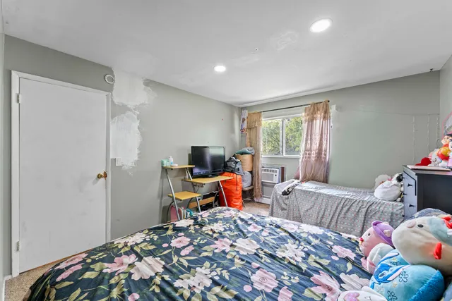 a bedroom with bed and a window