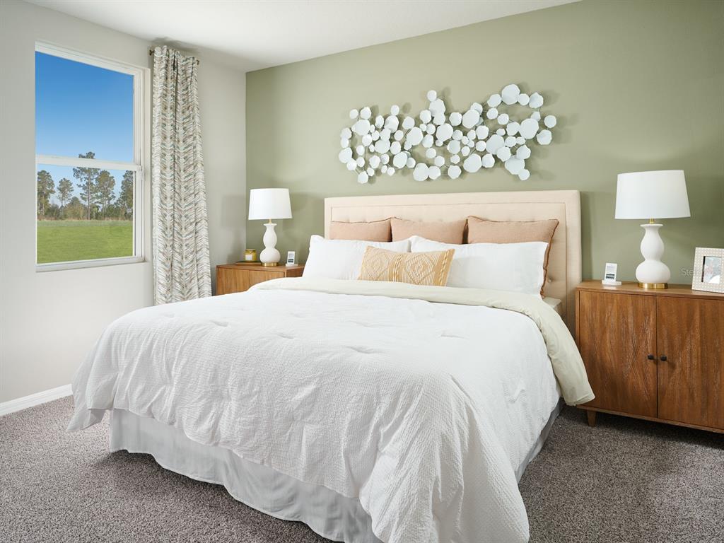 44505 Diamond Trail Punta Gorda, FL 33982 - Photo 6 of 7 a bedroom with a bed and a chandelier
